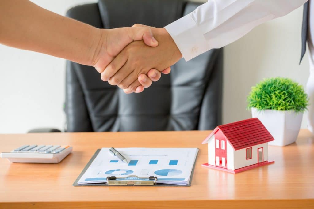 hands agent client shaking hands after signed contract buy new apartment