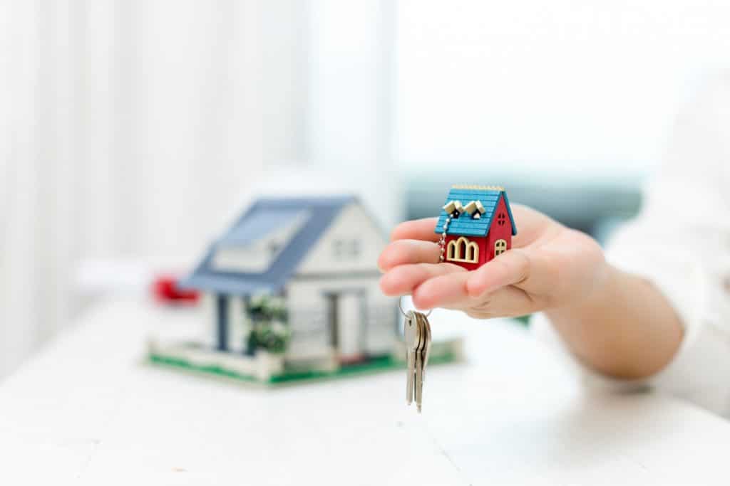 real estate agent with house model keys